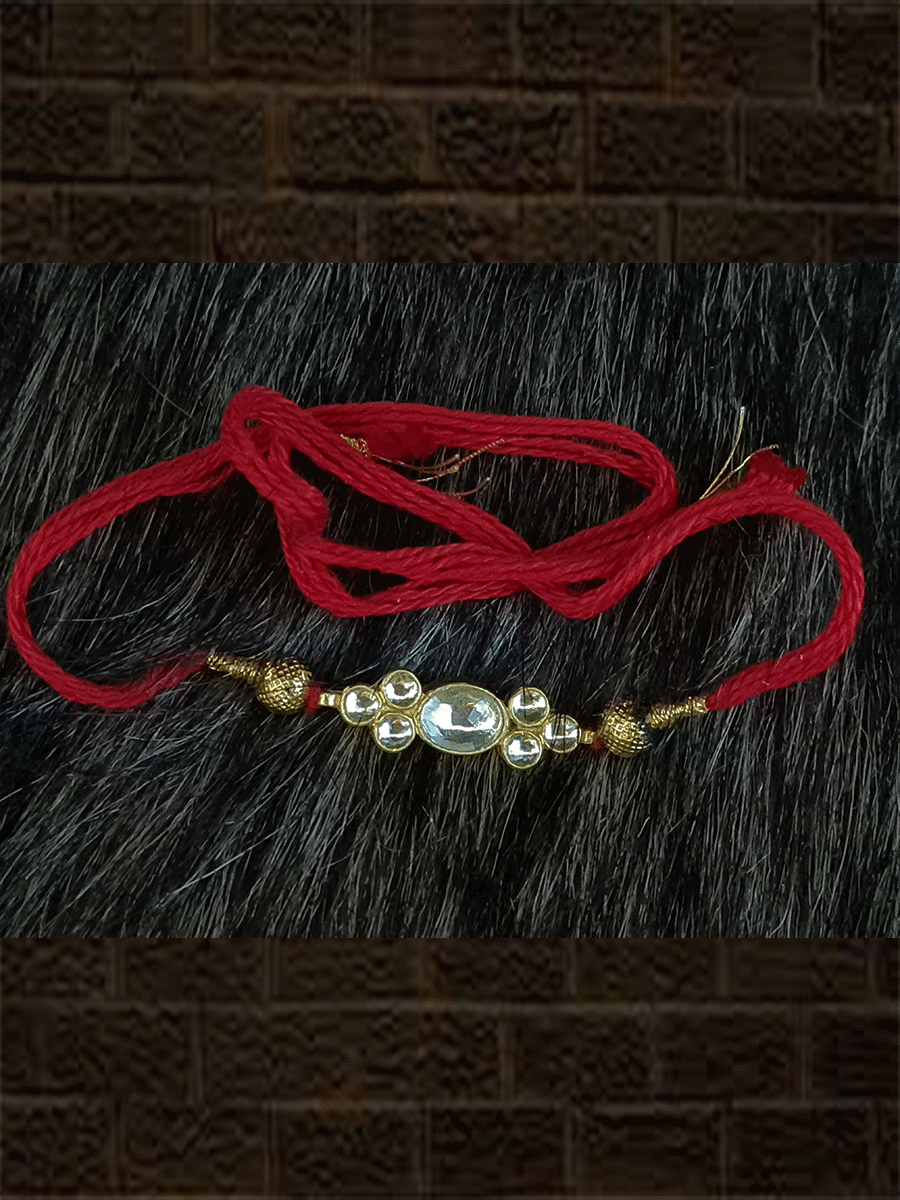 Elegant kundan rakhi in red and green thread with side gold beads - Odara Jewellery
