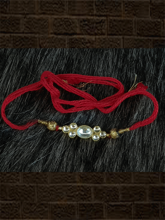 Elegant kundan rakhi in red and green thread with side gold beads - Odara Jewellery