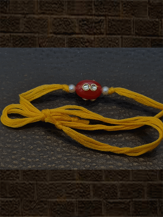 Oval orange glass bead kundan with side pearl  rakhi in yellow thread - Odara Jewellery