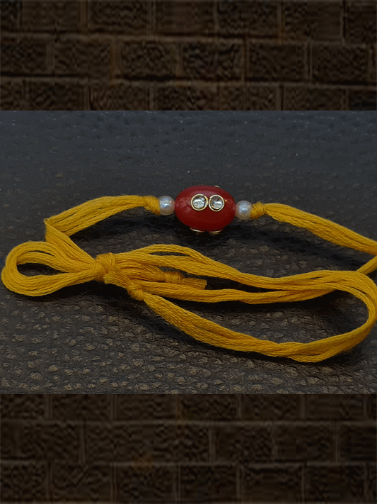 Oval orange glass bead kundan with side pearl  rakhi in yellow thread - Odara Jewellery