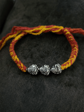 Sterling silver three ganpati ji rakhi in mouli - Odara Jewellery