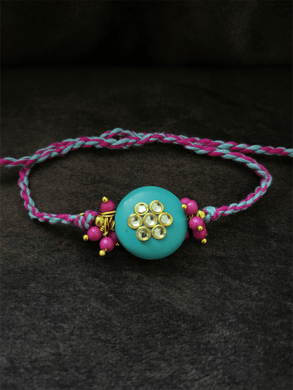 Ferozi round bead with kundan flower and pink bead cluster on both sides rakhi - Odara Jewellery
