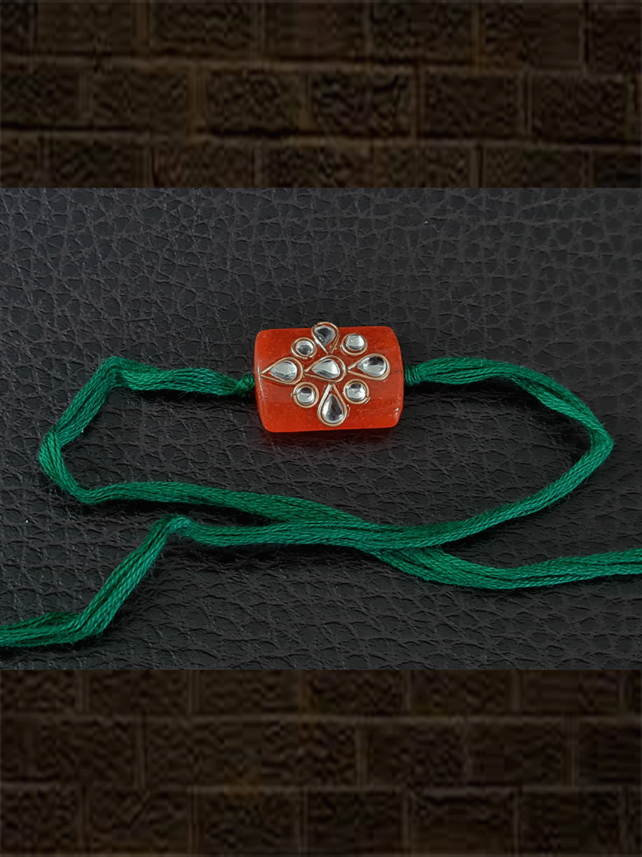 Orange rectangular glass bead with Kundan rakhi in mauli - Odara Jewellery