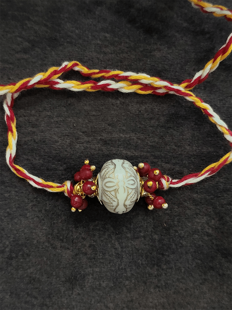 White antique paint bead with red bead cluster rakhi - Odara Jewellery