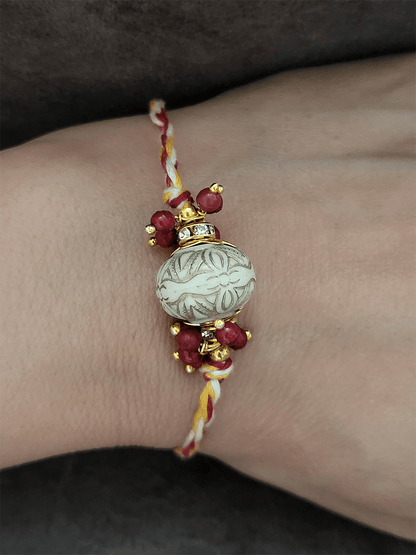 White antique paint bead with red bead cluster rakhi - Odara Jewellery