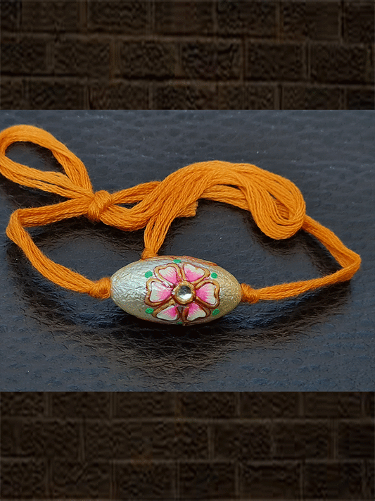 Orange thread oval white bead flower design kundan rakhi - Odara Jewellery