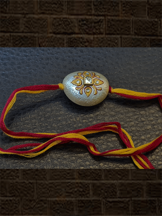 White bead hand painted in red and yellow colour with kundan rakhi in mauli - Odara Jewellery
