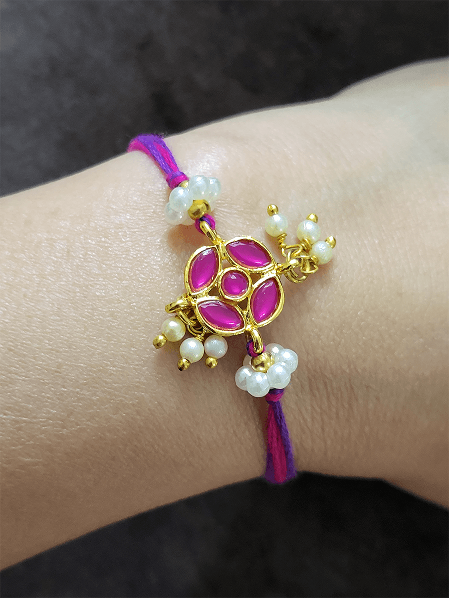 Stone studded flower shaped rakhi with pearly hangings - Odara Jewellery
