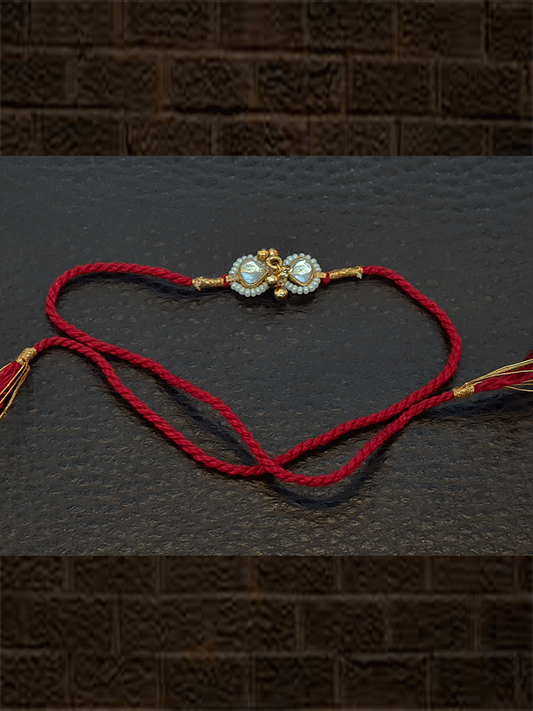Triangular kundan with ghunghru and pirohi work red thread rakhi - Odara Jewellery