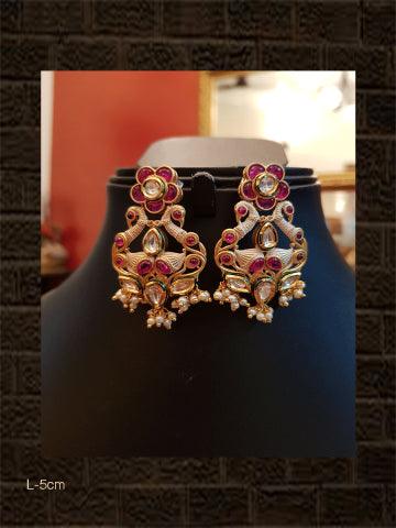 Ivory finish kundan earrings with ruby flower