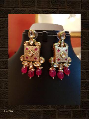 Ivory finish square kundan earring with ruby drops